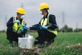 Two Environmental Engineers Inspect Water Quality and Take Water Samples Notes in The Field Near Farmland, Natural Water Sources Royalty Free Stock Photo