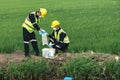 Two Environmental Engineers Take Water Samples at Natural Water Sources Near Farmland Maybe Contaminated by Toxic Waste or Royalty Free Stock Photo