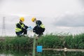 Two Environmental Engineers Take Water Samples at Natural Water Sources Near Farmland Maybe Contaminated by Toxic Waste or Royalty Free Stock Photo