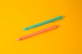 Two erasable pens on yellow background, flat lay Royalty Free Stock Photo