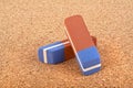 Two erasers on cork board Royalty Free Stock Photo