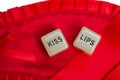 Two erotic dice for sexual game couple relation on red satin background texture isolated on white background top view with the Royalty Free Stock Photo