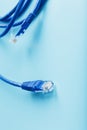 Two Ethernet Cable Connectors Patch cord cord close-up isolated on a blue background with free space Royalty Free Stock Photo