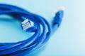 Two Ethernet Cable Connectors Patch cord cord close-up isolated on a blue background with free space Royalty Free Stock Photo