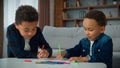 Two ethnic African American boys kids enjoy hobby art at home homework draw schoolboys brothers pupils siblings children Royalty Free Stock Photo