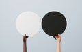 Two ethnic hands holding speech bubble speech bubbles, black and white Royalty Free Stock Photo