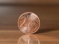 Two euro cent standing on a wodden table Royalty Free Stock Photo