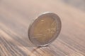 Two euro coin on a wooden surface Royalty Free Stock Photo