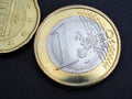 Two euro coins. The focus is on the name of the Euro Zone currency on the 1 euro coin. Close-up. Illustration about the economy, Royalty Free Stock Photo