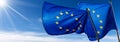 Two European Union Flags Blowing in the Wind on Blue Sky with Clouds Royalty Free Stock Photo