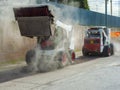 Two excavators perform milling of asphalt