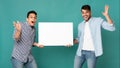 Two Excited Arab Men Showing Blank White Board, Studio Shot Royalty Free Stock Photo