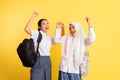 two excited high school girls in a pose celebrating graduation