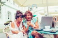 Two excited senior women reading good news on line with a laptop  in cafe Royalty Free Stock Photo