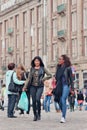 Two exotic girls walk at Dam Square, Amsterdam, Netherlands