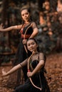 Two Exotic Indonesian Women holding an archery and pose wildly Royalty Free Stock Photo