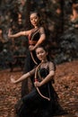 Two Exotic Indonesian Women holding an archery and pose wildly Royalty Free Stock Photo