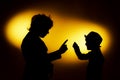 Two expressive boy's silhouettes showing emotions using gesticu Royalty Free Stock Photo