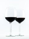 Two exquisite transparent glasses with red wine on a white background Royalty Free Stock Photo