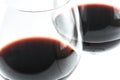 Two exquisite transparent glasses with red wine on a white background - close up Royalty Free Stock Photo