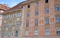 Two facades of historic buildings, located in the large square of Graz, superbly decorated, especially the one on the left.