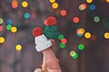 Two faceless romantic couple fingers in knitted hats over Christmas background