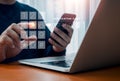 Two factor authentication or 2FA concept. Verification code with numbers pad press by man hand while using smart phone and laptop
