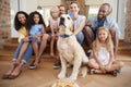 Two families celebrating pet dogÃ¯Â¿Â½s birthday at home
