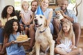 Two families celebrating pet dogÃ¯Â¿Â½s birthday at home