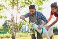 Two farmers, husband and wife tending to their goat on their farm