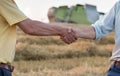 Two farmers shaking hands in field Royalty Free Stock Photo