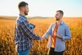 Two farmers shaking hands in soybean field. Royalty Free Stock Photo