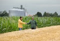 Farmers shaking hands in field Royalty Free Stock Photo