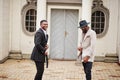 Two fashion black men. Fashionable portrait of african american male models. Wear suit, coat and hat Royalty Free Stock Photo