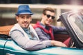 Two fashion man sitting in luxury retro cabriolet car Royalty Free Stock Photo