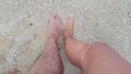 two feet on the beach sand Royalty Free Stock Photo