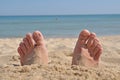 Two feet buried in sand Royalty Free Stock Photo
