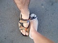 Two feet of a couple on the floor in the opposite direction Royalty Free Stock Photo