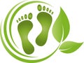 Two feet and leaves, foot care and podiatry logo Royalty Free Stock Photo