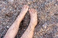 Child Legs On The Beach Full Of Small Pebbles On A Summer Day. Royalty Free Stock Photo