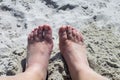 Two feet in the sand on a hot sunny day Royalty Free Stock Photo