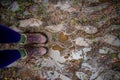 Two feet stading on a muddy, wet path Royalty Free Stock Photo