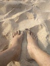 Two feet on white sand Royalty Free Stock Photo