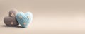 Two felted cute blue and brown pastel, romantic hearts on a beige background with copy space.