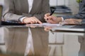 Two female accountants checking financial statement or counting by calculator income for tax form, hands close-up Royalty Free Stock Photo