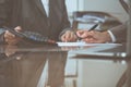 Two female accountants checking financial statement or counting by calculator income for tax form, hands close-up Royalty Free Stock Photo