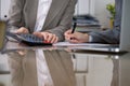 Two female accountants checking financial statement or counting by calculator income for tax form, hands close-up Royalty Free Stock Photo