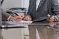 Two female accountants checking financial statement or counting by calculator income for tax form, hands close-up Royalty Free Stock Photo