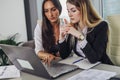 Two female accountants working together on financial report using laptop sitting at desk in account department Royalty Free Stock Photo