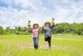 two female asian farmers holding young rice sprouts, working in paddy field on a sunny day Royalty Free Stock Photo